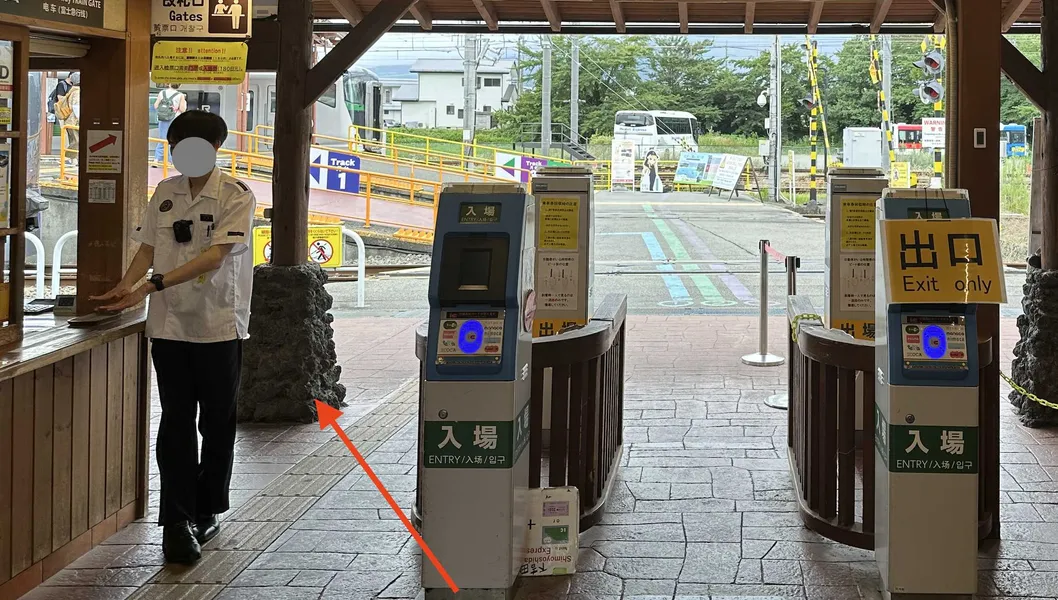 The staffed gate at Kawaguchiko Station, marked with a red arrow